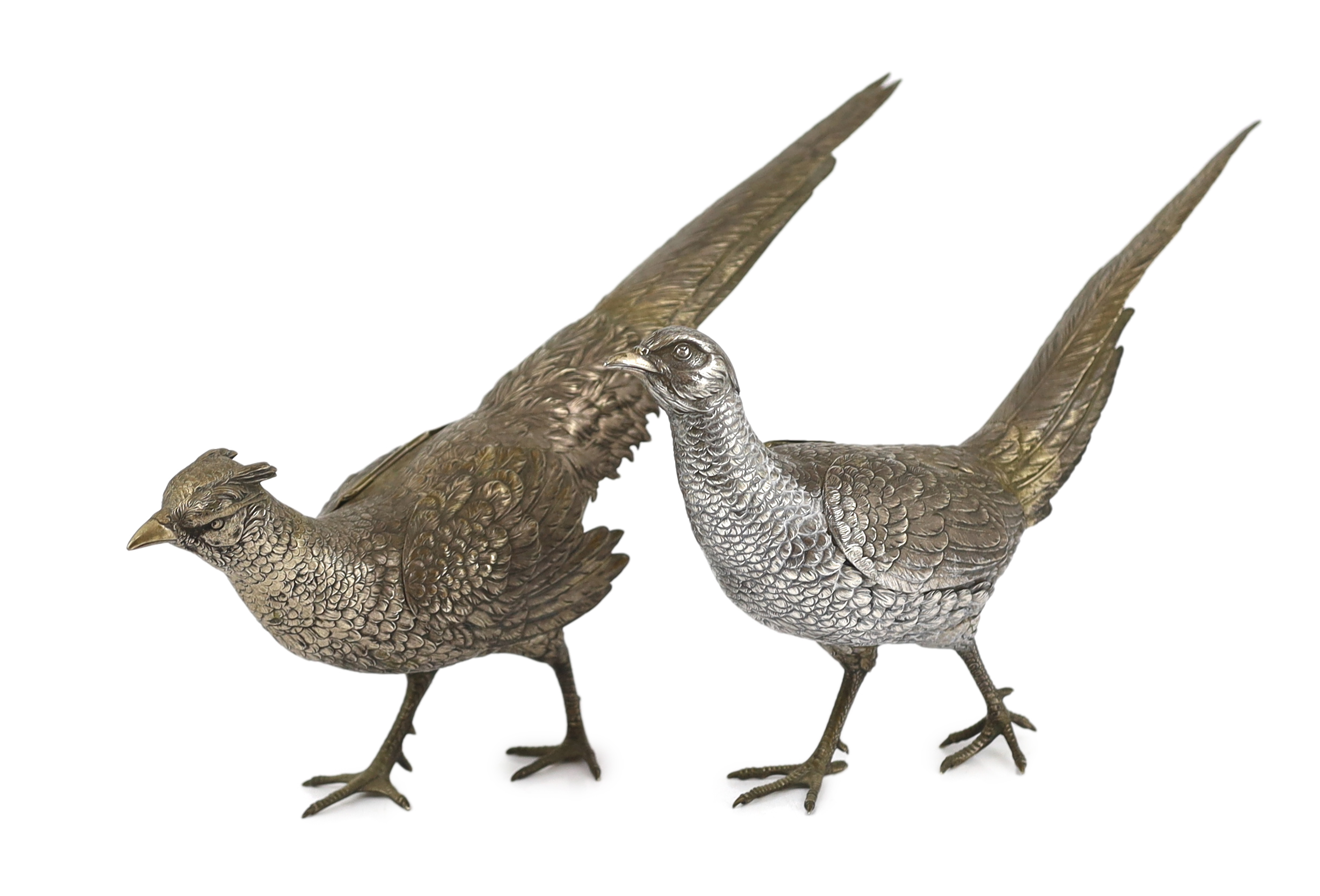 A large pair of German 800 standard silver free standing model pheasants with articulated wings, c.1930, 46cm long